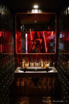 Partake NYC red tiled restroom